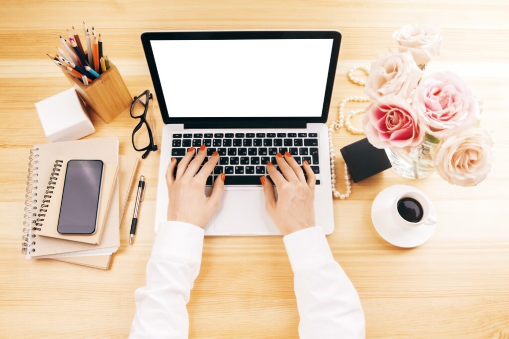 Streamlined workspace: laptop, calculator, and journal for focused productivity.