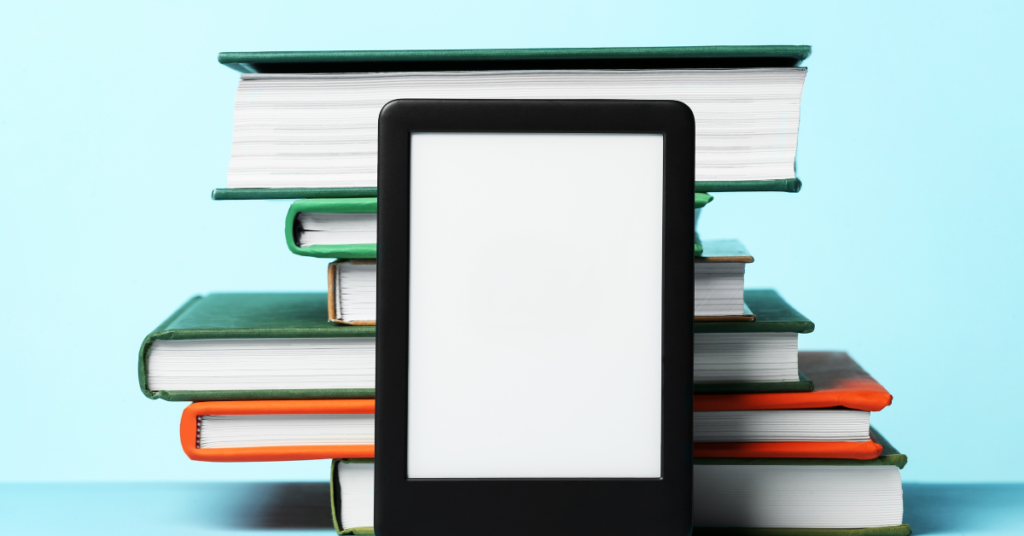 Transition from paper to digital effortlessly; an e-reader lies on top of a pile of assorted books.