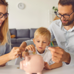 Family teaching financial literacy by saving coins in a piggy bank.